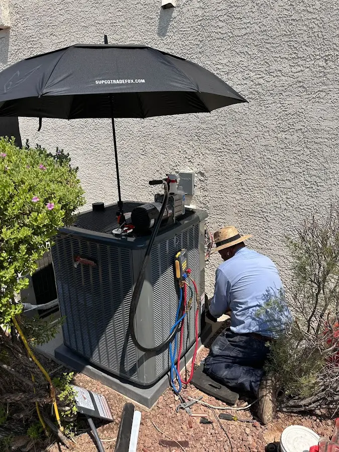HVAC technician performing outdoor AC maintenance in Neshannock
